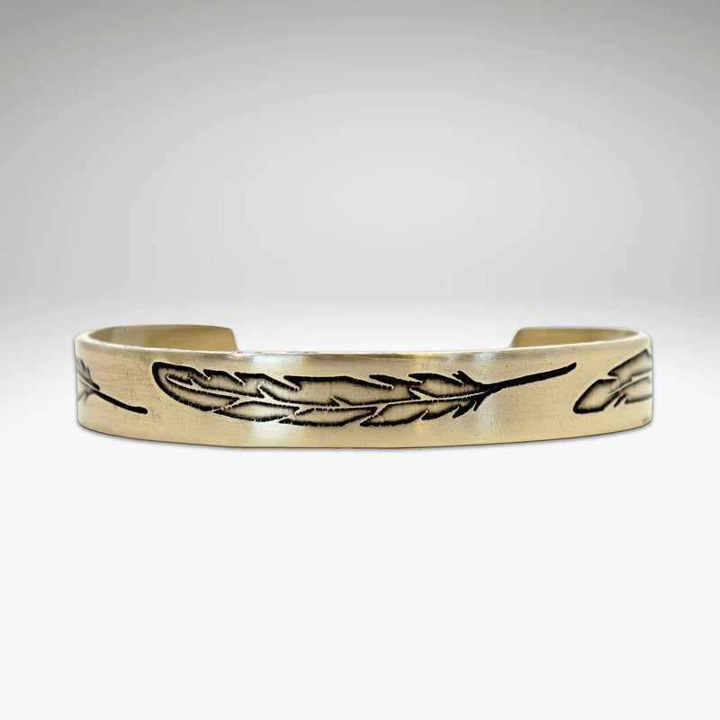 Feather Cuff Bracelet in antique brass finish featuring engraved feathers, adjustable design for a majestic look.