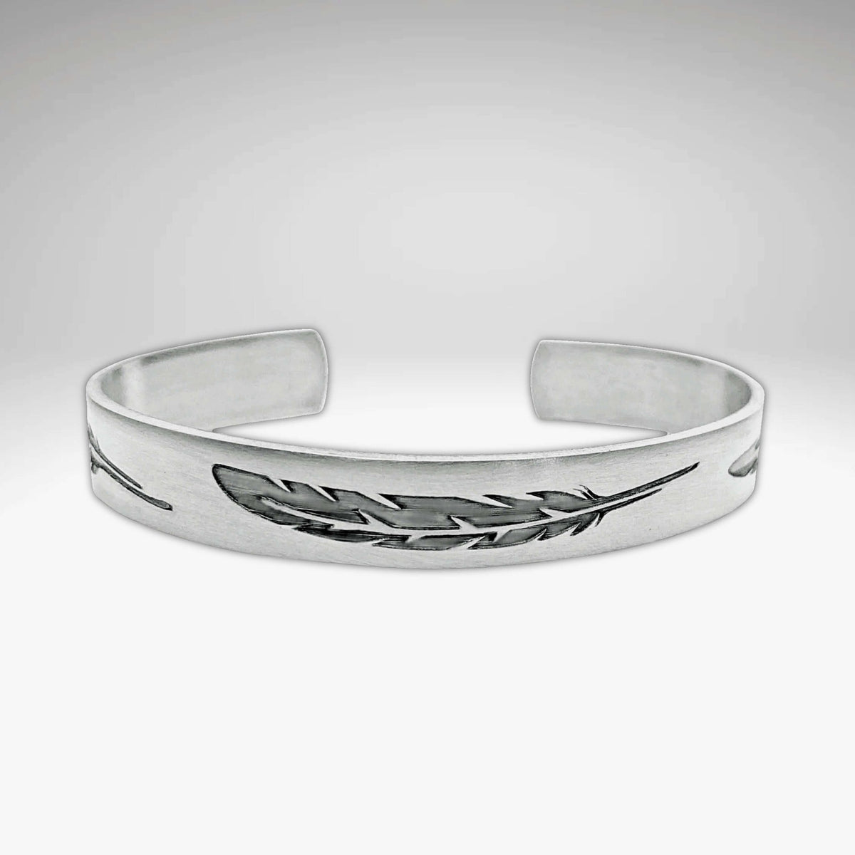 Feather Cuff Bracelet in matte silver, showcasing intricate feather designs, perfect for nature lovers and outdoor activities.