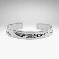 Feather Cuff Bracelet in matte silver, showcasing intricate feather designs, perfect for nature lovers and outdoor activities.