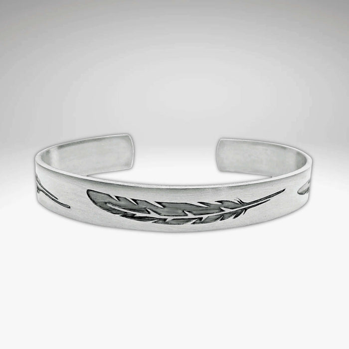 Feather Cuff Bracelet in matte silver, showcasing intricate feather designs, perfect for nature lovers and outdoor activities.