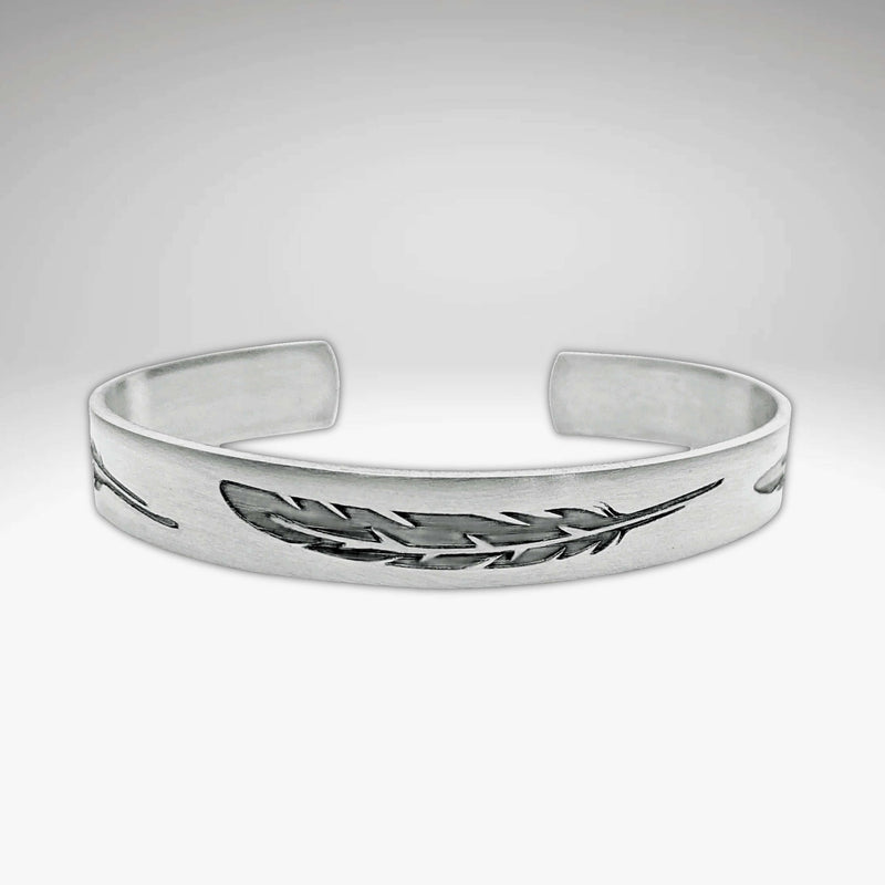 Feather Cuff Bracelet in matte silver, showcasing intricate feather designs, perfect for nature lovers and outdoor activities.