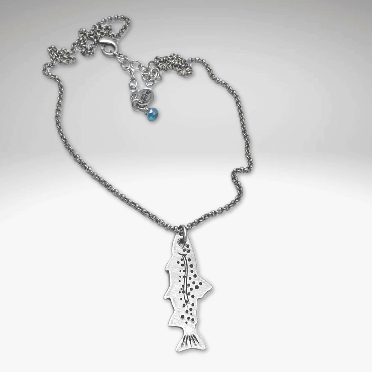 Fishin' Necklace featuring a silver fish pendant on a cable chain, representing aquatic life.
