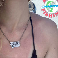 Fishing In Montana Necklace featuring intricate trout design on state outline, worn by a model.