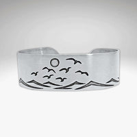 Fly Over 2 Bracelet featuring a serene beach scene with waves and birds, capturing a coastal vibe.