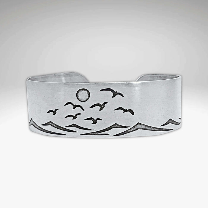 Fly Over 2 Bracelet featuring a serene beach design with waves and birds, capturing a sunny shore atmosphere.