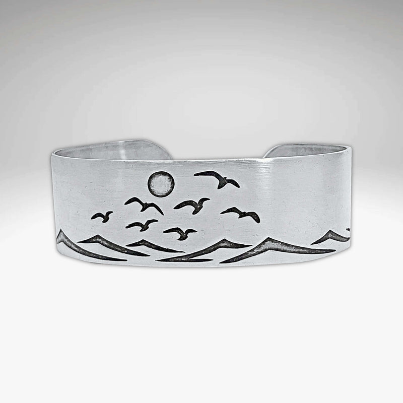 Fly Over 2 Bracelet featuring a serene beach scene with waves and birds, capturing a coastal vibe.
