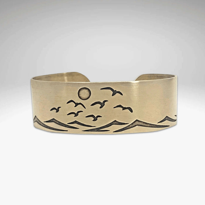Fly Over 2 Bracelet showcasing a beach scene with waves and birds, capturing the essence of the shore.