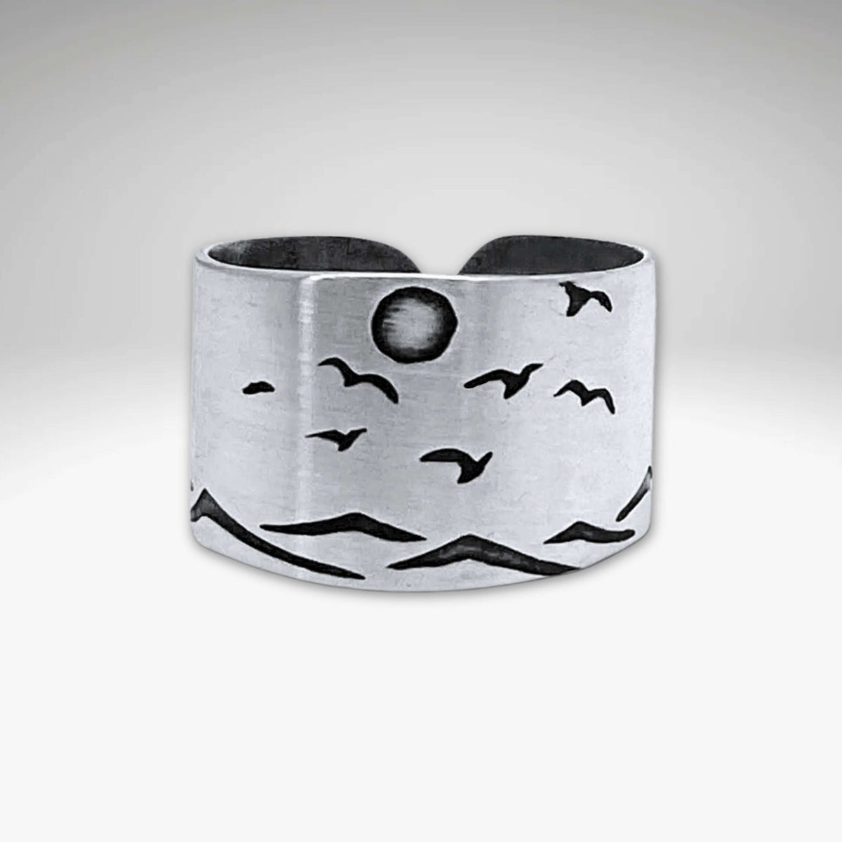 Flyover Adjustable Ring with Mountains, Waves, Full Moon and Birds, crafted in matte silver, showcasing a scenic outdoor design.