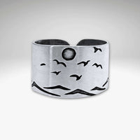 Flyover Adjustable Ring with Mountains, Waves, Full Moon and Birds, crafted in matte silver, showcasing a scenic outdoor design.
