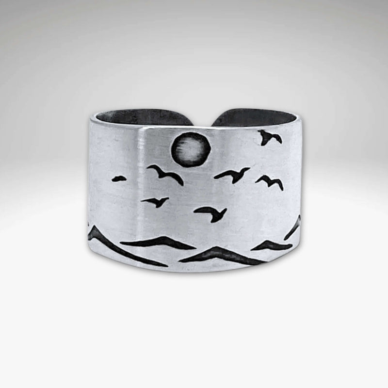 Flyover Adjustable Ring with Mountains, Waves, Full Moon and Birds, crafted in matte silver, showcasing a scenic outdoor design.