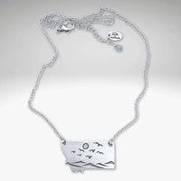 Flyover Montana - Necklace with Mountains birds and sun showcasing silver pendant of mountains, birds, and sun.