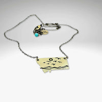 Flyover Montana - Necklace with Mountains birds and sun featuring a Montana pendant with birds and sun design.