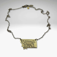 Four Cubs - Montana Bear Necklace in antique brass finish, featuring bear design and adjustable length.
