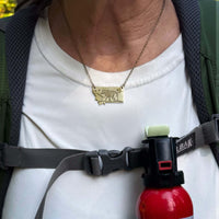 Four Cubs - Montana Bear Necklace worn by a person, showcasing a unique handmade design in antique brass finish.