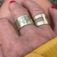 Fox Run Adjustable Ring shown on hand, featuring matte silver finish and animal design, handmade in Montana.