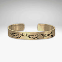 Fox Run Cuff Bracelet featuring playful fox designs in antique brass finish.