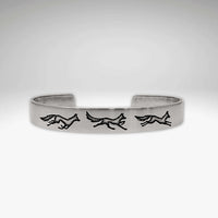 Fox Run Cuff Bracelet showcasing three playful foxes on a matte silver cuff.