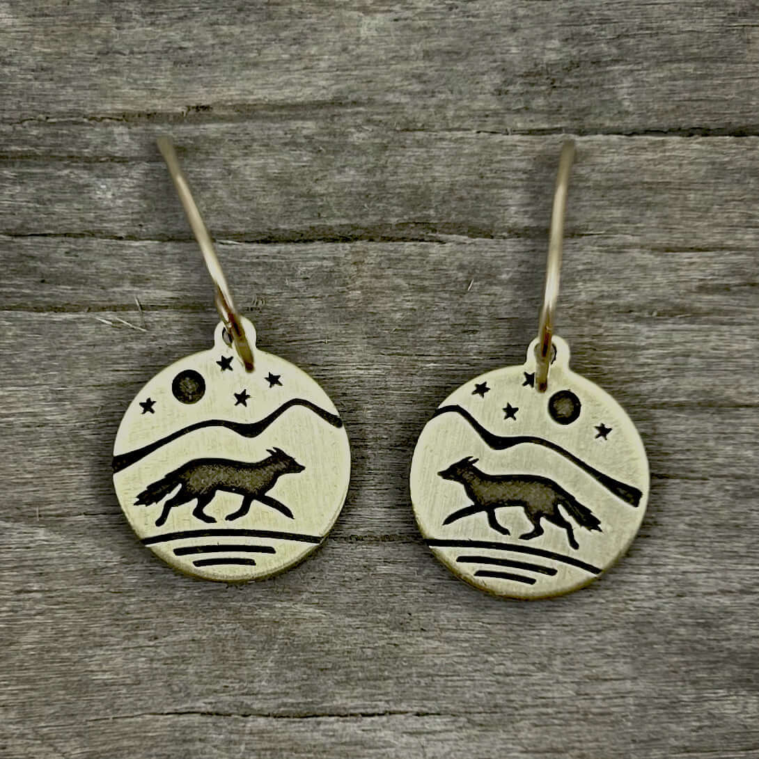 Fox Run Earrings showcasing etched fox design on brass with moon and stars, perfect for nature enthusiasts.