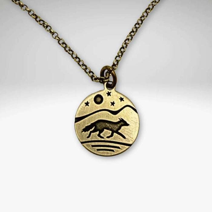 Fox Run Necklace featuring a handmade pendant of a fox running under a night sky, available in Antique Brass finish.
