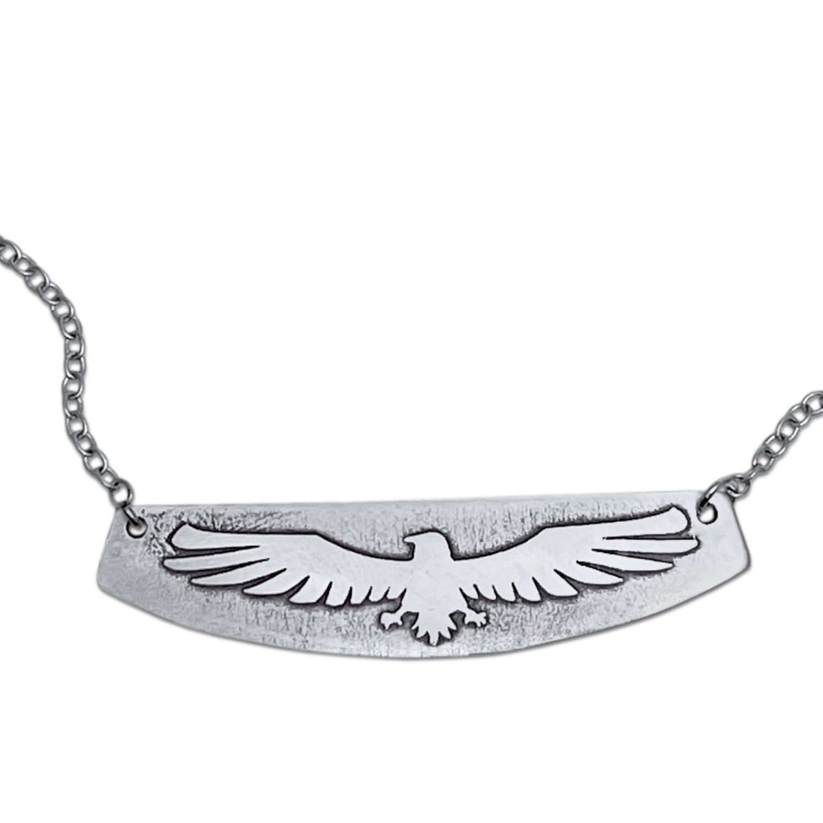 Freebird Necklace featuring an etched eagle design on a solid brass pendant with a small cable chain.