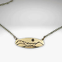 Glacier View Necklace in antique brass finish with mountain design pendant on adjustable cable chain.