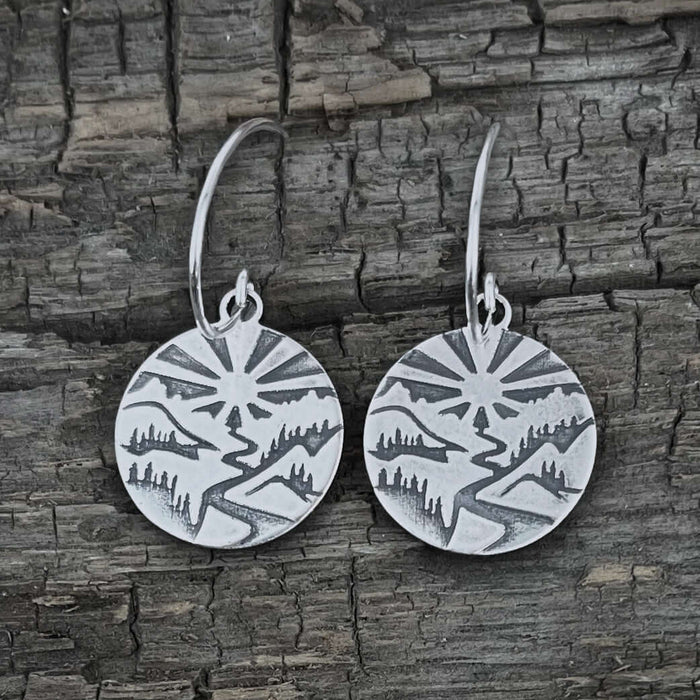 Going to the Sun Earrings showcasing a nature-inspired design etched in silver.