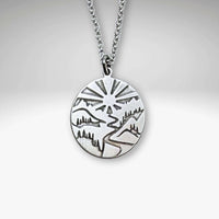 Going to the Sun Necklace featuring a detailed mountain pendant on an adjustable chain.