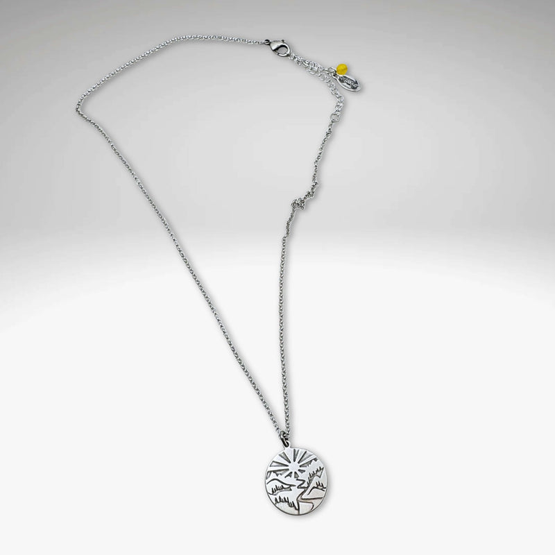 Going to the Sun Necklace featuring a mountain pendant on an adjustable silver chain.