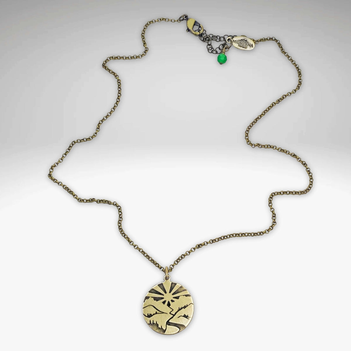 Going to the Sun Necklace featuring a mountain pendant on a rolo chain, available in Antique Brass finish.