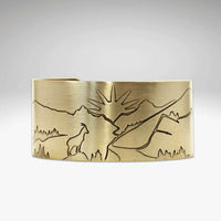 Going to the Sun Road Cuff Bracelet featuring etched mountains, sun goat, and road in antique brass finish.