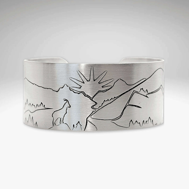 Going to the Sun Road Cuff Bracelet featuring mountain and sun goat engraving in matte silver finish.