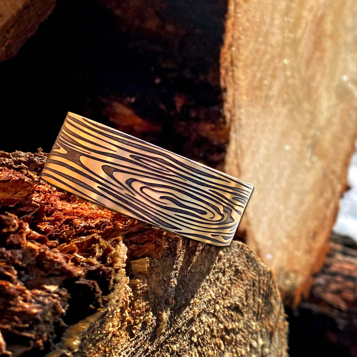 Grain Cuff Bracelet designed to resemble wood fibers against rustic wood background.