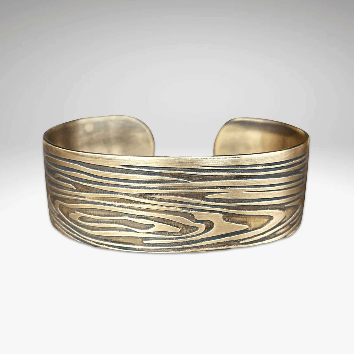 Grain Cuff Bracelet showcasing a wood fiber design in a stylish gold finish, perfect for nature lovers.