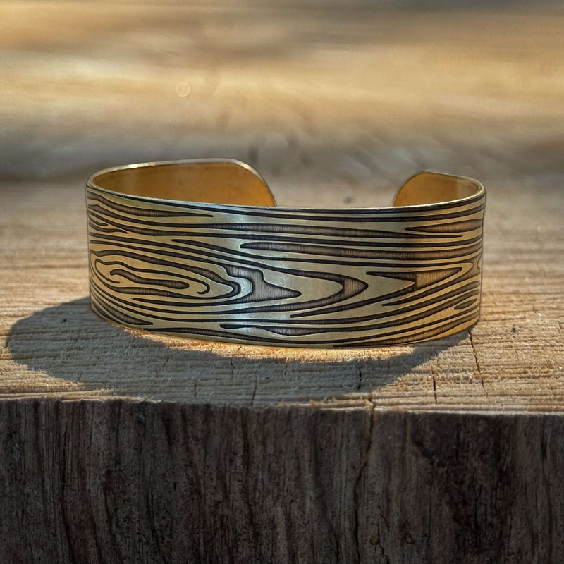Grain Cuff Bracelet showcasing wood fiber design, adjustable cuff on wooden background, 5.75" long and 3/4" wide.