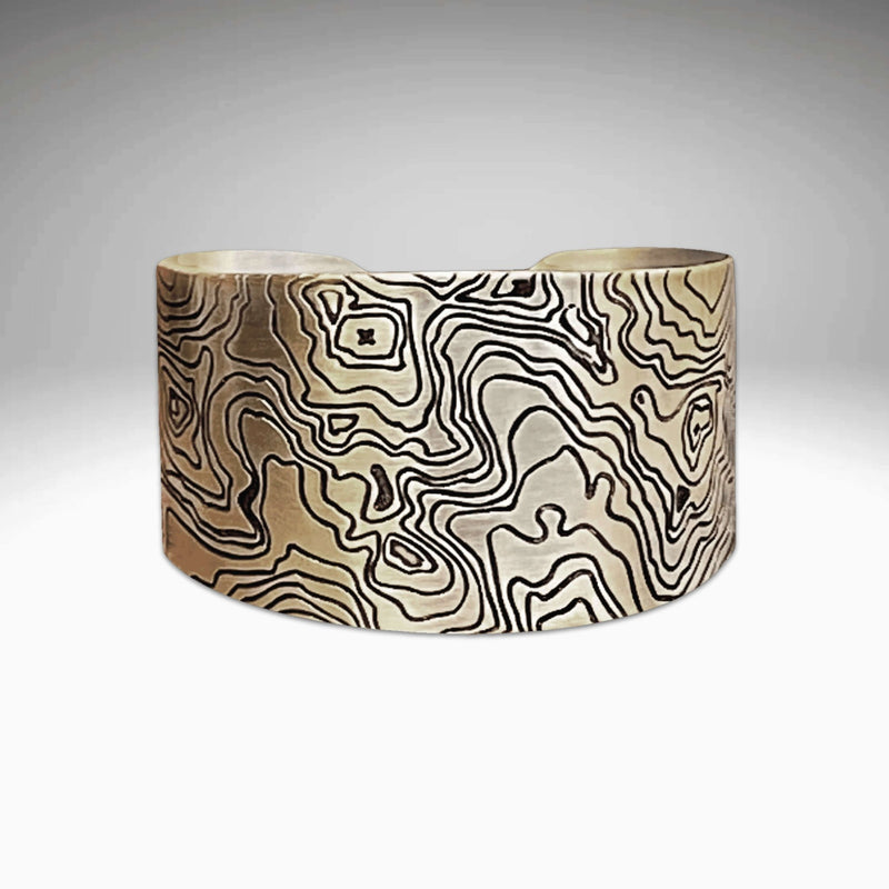 Grand Cuff in matte silver with intricate patterns, adjustable bracelet measuring 1.4" wide and 5.75" long.