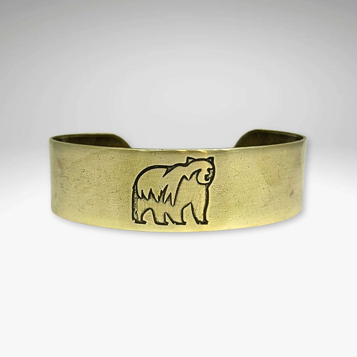 Griz Cuff Bracelet featuring a grizzly bear silhouette on a sleek cuff design, perfect for nature lovers.