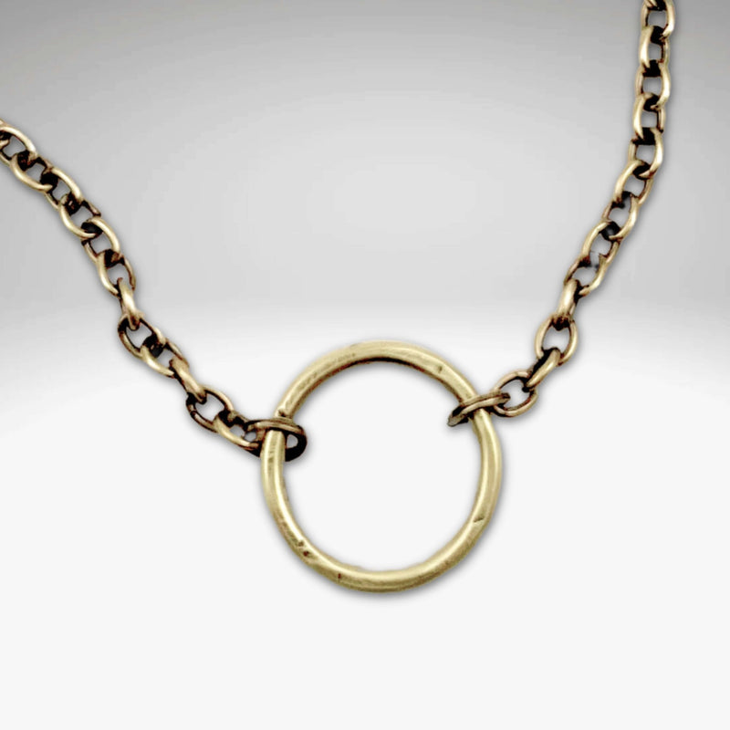 Halo Necklace featuring a hammered halo pendant on an adjustable cable chain in antique brass finish.