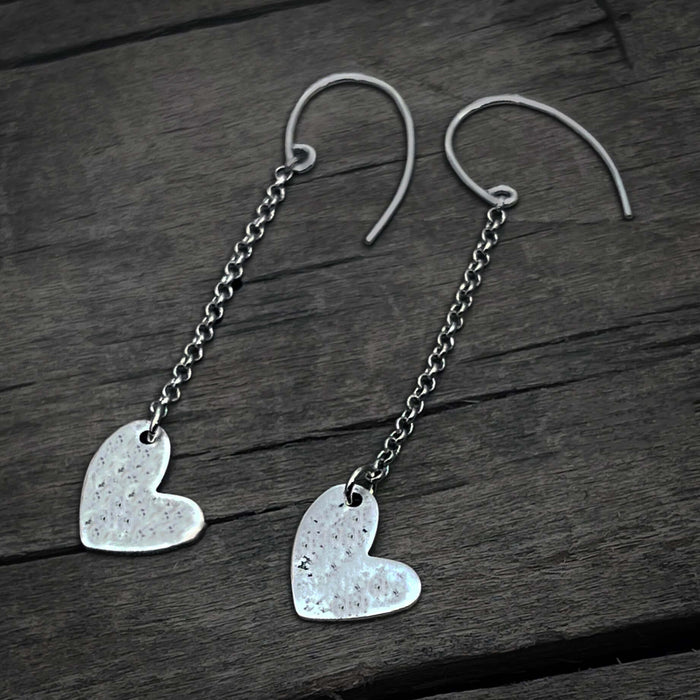 Heart Drop Earrings featuring hand-hammered asymmetrical hearts on sterling silver earwires.