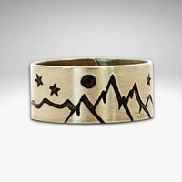 High Alpine Adjustable Ring featuring mountain and star designs in antique brass finish.