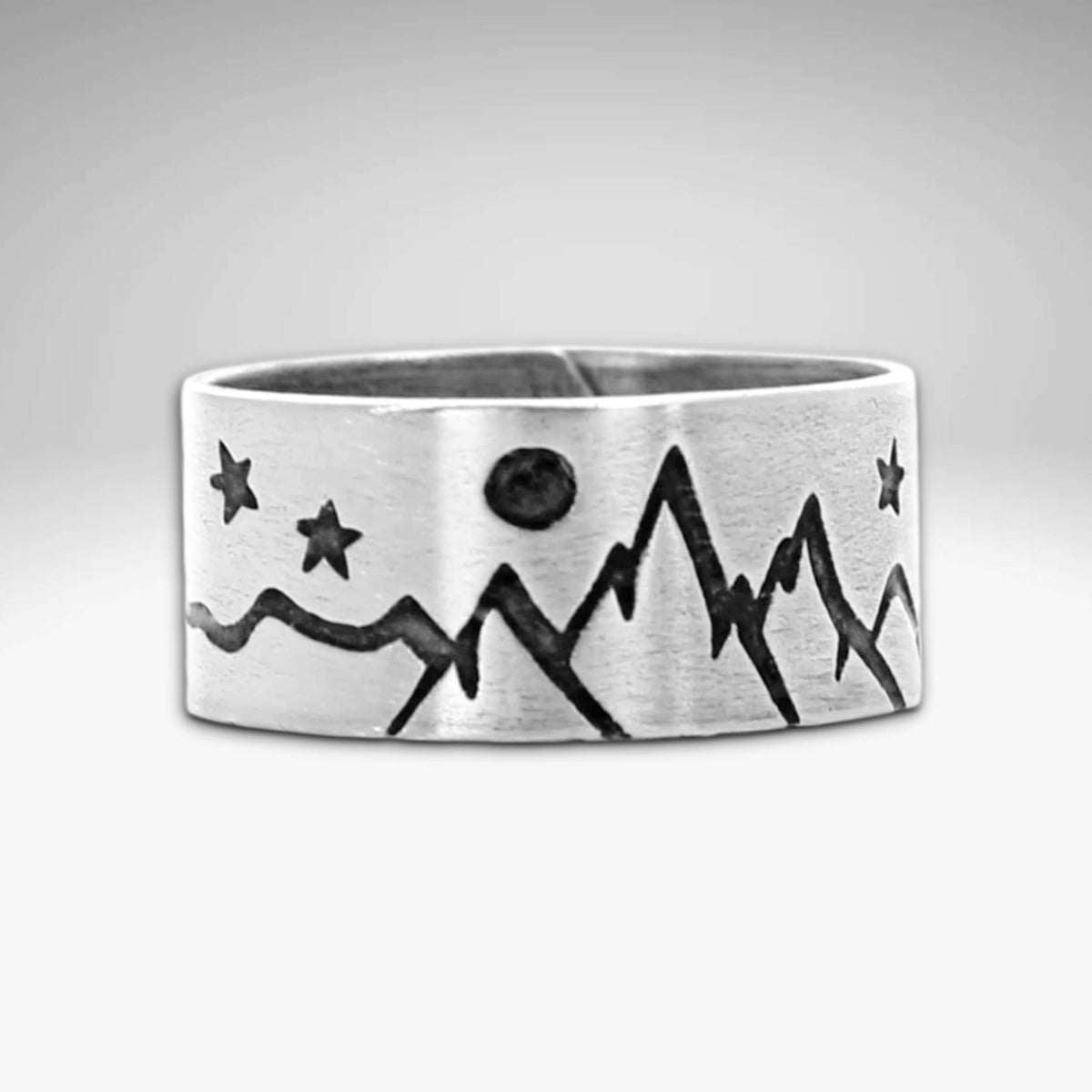 High Alpine Adjustable Ring showcasing mountain and star design in matte silver finish.