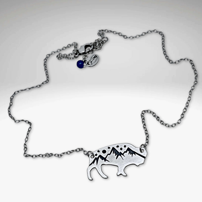 High Alpine Bison Necklace featuring a cutout bison with mountain design on an adjustable silver chain.