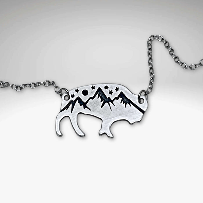 High Alpine Bison Necklace showcasing a bison silhouette with mountain and star designs, on a delicate chain.