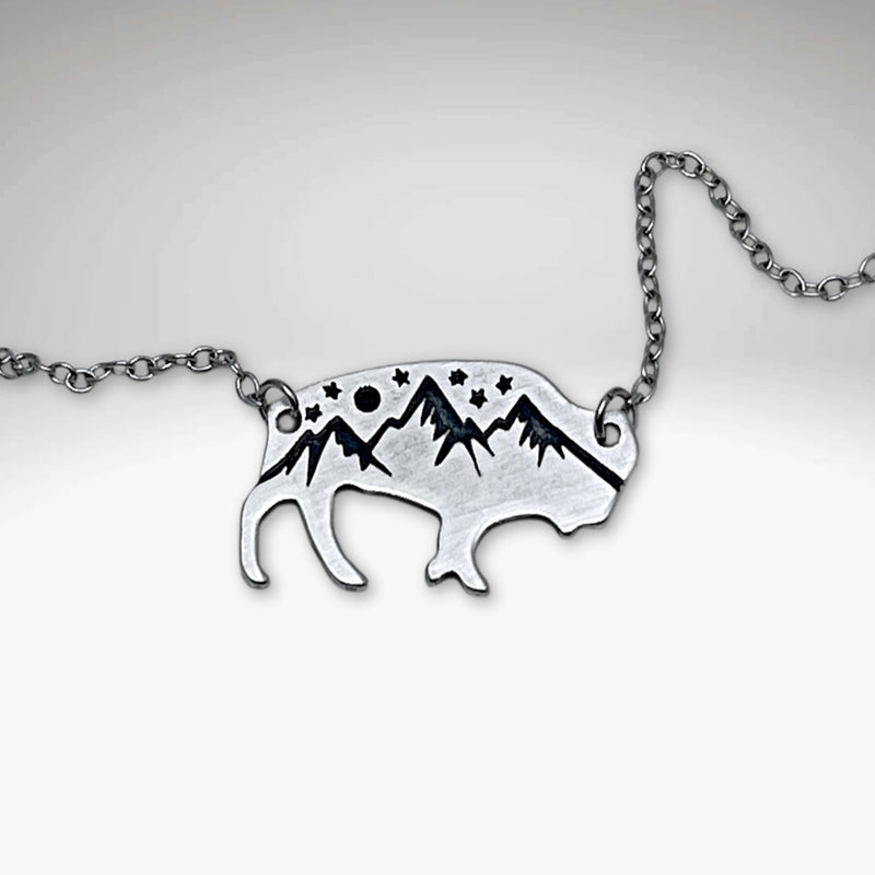 High Alpine Bison Necklace showcasing a bison silhouette with mountain and star designs, on a delicate chain.