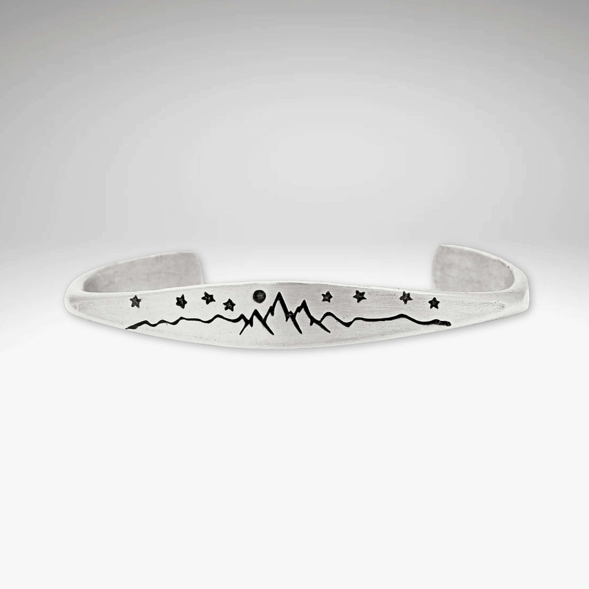 High Alpine Cuff Bracelet featuring etched mountains, stars, and a full moon design.