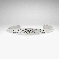 High Alpine Cuff Bracelet featuring etched mountains, stars, and a full moon design.