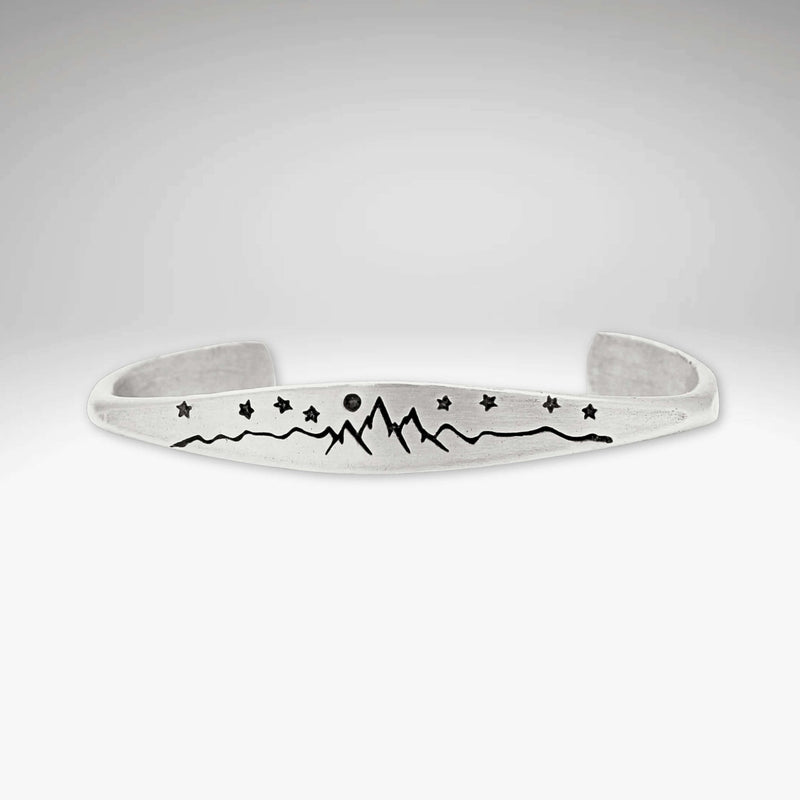 High Alpine Cuff Bracelet featuring etched mountains, stars, and a full moon design.