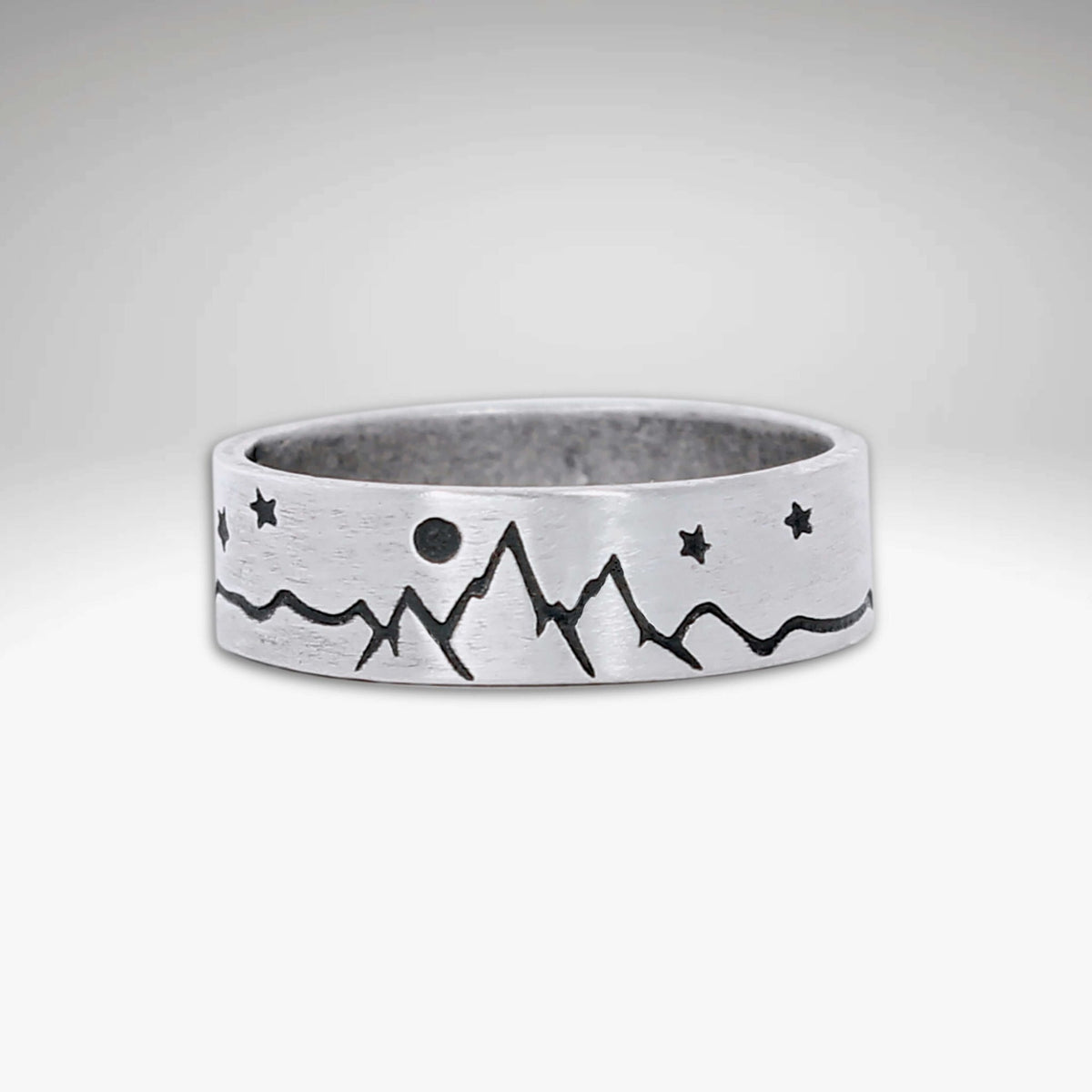 High Alpine Mountain Ring featuring mountain and star design in matte silver finish.
