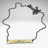 High Alpine Necklace featuring a brass etched mountain design on an adjustable chain.