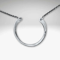 Horseshoe Necklace featuring a semi-circle pendant with a hammered finish on a delicate rolo chain.