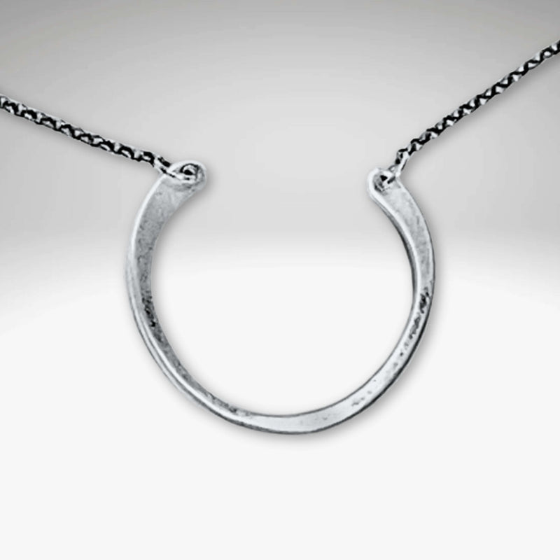 Horseshoe Necklace featuring a semi-circle pendant with a hammered finish on a delicate rolo chain.